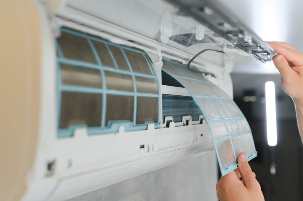 Service man is cleaning, repair and maintenance of air conditioner